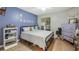 Cozy bedroom with light flooring, built-in shelving and dresser at 8801 Village Green Blvd, Clermont, FL 34711