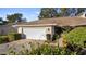 Single-story home with attached garage and manicured landscaping at 8801 Village Green Blvd, Clermont, FL 34711
