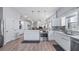 Open concept kitchen with white cabinets and stainless steel appliances at 8801 Village Green Blvd, Clermont, FL 34711