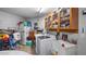 Functional laundry room with washer, dryer, cabinets, and extra storage at 8801 Village Green Blvd, Clermont, FL 34711
