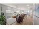 Open living room with hardwood floors, comfortable seating, and large windows at 8801 Village Green Blvd, Clermont, FL 34711