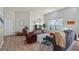 Bright and airy living room featuring hardwood floors and comfortable furnishings at 8801 Village Green Blvd, Clermont, FL 34711