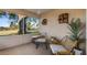 Relaxing screened porch with outdoor seating and view of the golf course at 8801 Village Green Blvd, Clermont, FL 34711