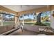 Spacious screened porch with swing, seating, and tranquil golf course view at 8801 Village Green Blvd, Clermont, FL 34711