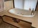 Oval soaking tub with tile surround and built-in seating at 110 N Volusia Ave, Pierson, FL 32180