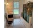 Bathroom with tub, shower, and window at 110 N Volusia Ave, Pierson, FL 32180