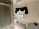 Bathroom with shower, toilet, and window at 110 N Volusia Ave, Pierson, FL 32180