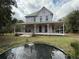 Two story home with a wrap around porch and pond at 110 N Volusia Ave, Pierson, FL 32180