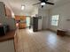 Bright kitchen with tile floors, wood cabinets, and access to backyard at 110 N Volusia Ave, Pierson, FL 32180