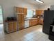 Spacious kitchen with ample cabinet space, tile floors and stainless steel fridge at 110 N Volusia Ave, Pierson, FL 32180