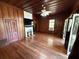 Living room with hardwood floors and wood walls at 110 N Volusia Ave, Pierson, FL 32180