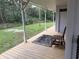Long porch with wooden floors and seating area at 110 N Volusia Ave, Pierson, FL 32180