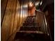 Wooden staircase with a patterned carpet runner at 110 N Volusia Ave, Pierson, FL 32180