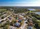 Aerial view of neighborhood with lake and home with pool at 1118 Stratton Ave, Groveland, FL 34736