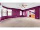 Spacious bedroom with purple walls and ceiling fan at 1121 Paradise Dr, Lady Lake, FL 32159