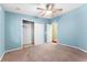 Bedroom with ceiling fan and neutral carpeting at 1121 Paradise Dr, Lady Lake, FL 32159
