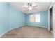 Spacious bedroom with two windows and ceiling fan at 1121 Paradise Dr, Lady Lake, FL 32159