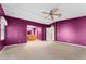 Spacious bedroom with purple walls, carpet, and ceiling fan at 1121 Paradise Dr, Lady Lake, FL 32159