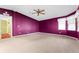 Bedroom with purple walls and ceiling fan at 1121 Paradise Dr, Lady Lake, FL 32159