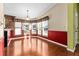 Dining room with wood floors and red wainscoting at 1121 Paradise Dr, Lady Lake, FL 32159