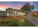 Single-story manufactured home with carport and landscaped lawn at 1121 Paradise Dr, Lady Lake, FL 32159