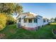 White single-wide manufactured home with a brick base and spacious lawn at 1121 Paradise Dr, Lady Lake, FL 32159