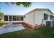 Rear view of the home showing a screened porch and patio at 1121 Paradise Dr, Lady Lake, FL 32159