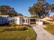 Single-story home with carport and landscaped yard at 1121 Paradise Dr, Lady Lake, FL 32159