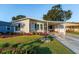 Single-story home with carport and well-maintained yard at 1121 Paradise Dr, Lady Lake, FL 32159