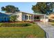 Single-story home with carport and manicured lawn at 1121 Paradise Dr, Lady Lake, FL 32159