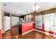 Kitchen with red accents, wood floors, and an island at 1121 Paradise Dr, Lady Lake, FL 32159