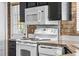 White appliances and dark cabinets in the kitchen at 1121 Paradise Dr, Lady Lake, FL 32159