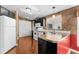 Kitchen boasts dark cabinetry, white appliances, and laminate flooring at 1121 Paradise Dr, Lady Lake, FL 32159