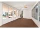 Bright sunroom with light brown carpet, ceiling fan and multiple windows at 1121 Paradise Dr, Lady Lake, FL 32159