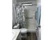 Clean bathroom with shower stall, toilet, and grab bars at 12 Hilly Way, Fruitland Park, FL 34731