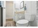 Clean bathroom with a toilet, sink, and a small cabinet at 12 Hilly Way, Fruitland Park, FL 34731