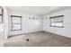 Bright bedroom with neutral walls, carpet flooring, and two windows at 12 Hilly Way, Fruitland Park, FL 34731