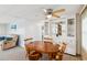 Bright dining area with a wooden table and chairs, near a comfy couch at 12 Hilly Way, Fruitland Park, FL 34731