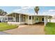 Inviting single-story home with a convenient carport, screened-in porch, and well-maintained lawn at 12 Hilly Way, Fruitland Park, FL 34731