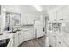 White kitchen with new appliances and gray flooring at 12 Hilly Way, Fruitland Park, FL 34731
