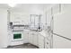 Clean white kitchen with modern appliances and a corner sink at 12 Hilly Way, Fruitland Park, FL 34731