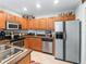 Kitchen boasts stainless steel appliances and ample wood cabinetry at 1200 S 7Th St, Leesburg, FL 34748