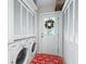 Convenient laundry room with washer, dryer, and ample storage at 1200 S 7Th St, Leesburg, FL 34748