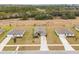 Aerial view of three single-Gathering homes on a quiet street at 12066 Callicarpa Ln, Leesburg, FL 34788