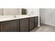 Double vanity bathroom with dark cabinets at 12066 Callicarpa Ln, Leesburg, FL 34788
