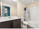 Clean bathroom with a shower/tub combo and dark vanity at 12066 Callicarpa Ln, Leesburg, FL 34788