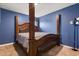 Spacious bedroom with a large wooden post bed at 12066 Callicarpa Ln, Leesburg, FL 34788