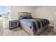 Bedroom with a queen-size bed and nightstand at 12066 Callicarpa Ln, Leesburg, FL 34788