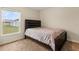 Smaller bedroom with a double bed and backyard view at 12066 Callicarpa Ln, Leesburg, FL 34788