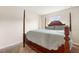 Bright bedroom featuring a wooden post bed at 12066 Callicarpa Ln, Leesburg, FL 34788